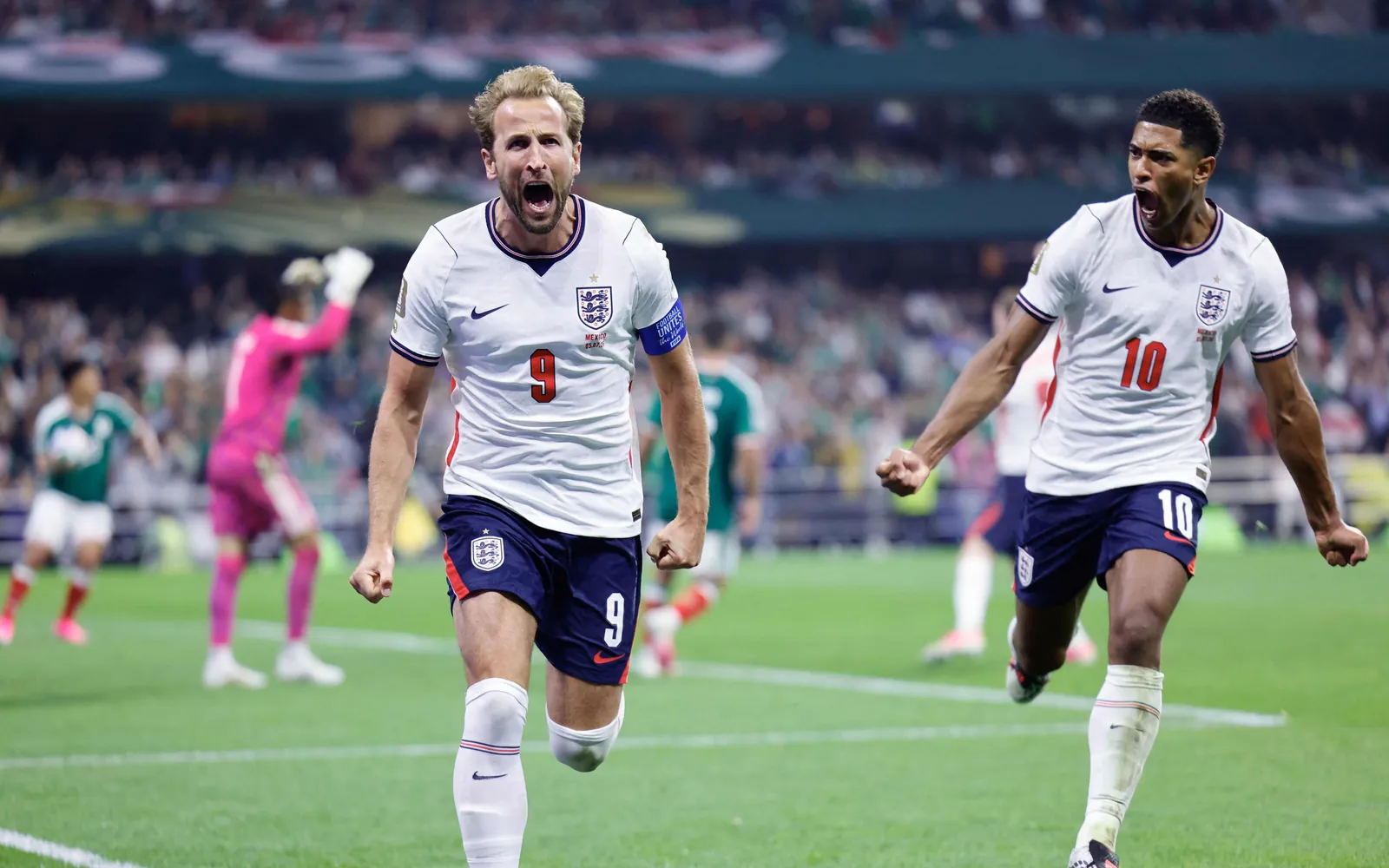England's Harry Kane (L) and Jude Bellingham celebrate a goal.