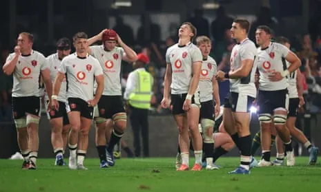The Wales players react at full-time